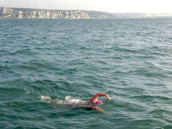 Deborah Herridge during her Isle of Wight swim, with the White Cliffs of Dover in the background. PPP-170913-094637001