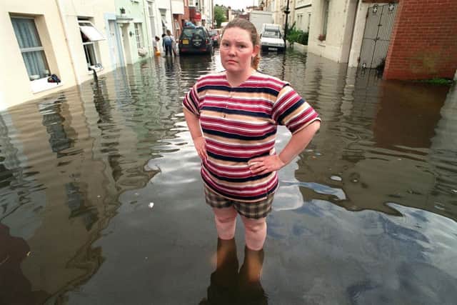 Jacqueline Redman knee-deep in flood water in Somerset Road, Southsea.