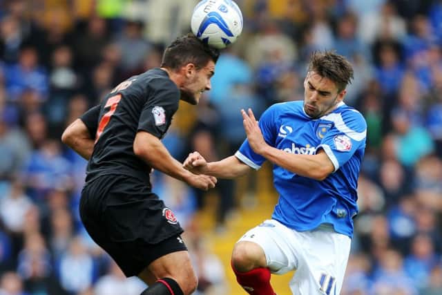 Gareth Evans, left, challenges Ricky Holmes for the ball during Fleetwood's only visit to Fratton Park in September 2013