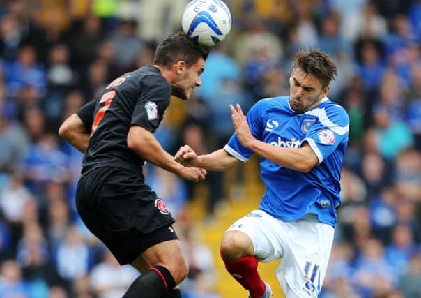 Gareth Evans, left, challenges Ricky Holmes for the ball during Fleetwood's only visit to Fratton Park in September 2013
