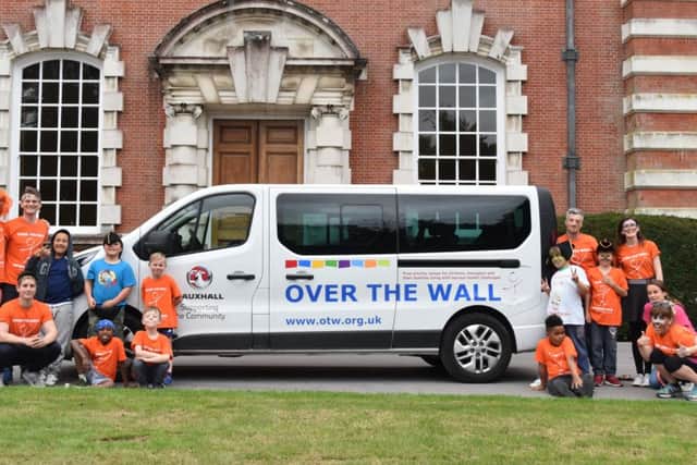 Children and volunteers from Over The Wall with their new minibus, which was donated by Vauxhall