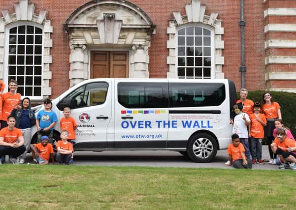 Children and volunteers from Over The Wall with their new minibus, which was donated by Vauxhall
