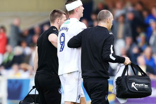 Oliver Hawkins is helped off the pitch at Kingsmeadow Picture: Joe Pepler