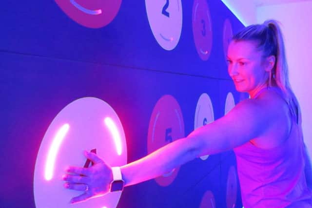 Personal trainer Kelly Oughton tries her hand at the interactive wall in the PRAMA studio