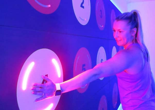 Personal trainer Kelly Oughton tries her hand at the interactive wall in the PRAMA studio