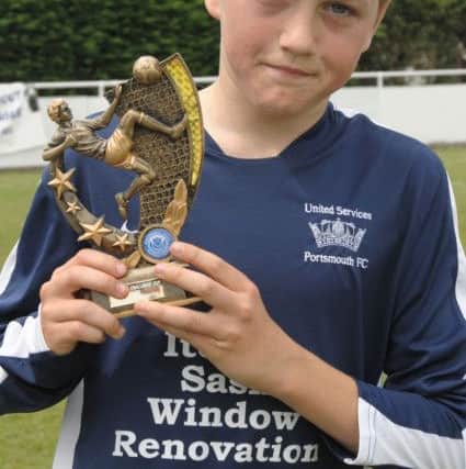 Ryan Pennery showed huge potential as a youngster. Here he is celebrating the man-of-the-match award when United Services beat East Lodge in the Under-15 Challenge Cup final