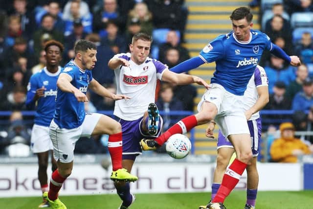 Jamal Lowe, background, watches Oliver Hawkins on his Pompey debut. Picture: Joe Pepler
