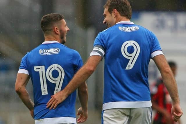 Conor Chaplin, left, with Pompey skipper Brett Pitman Picture: Joe Pepler