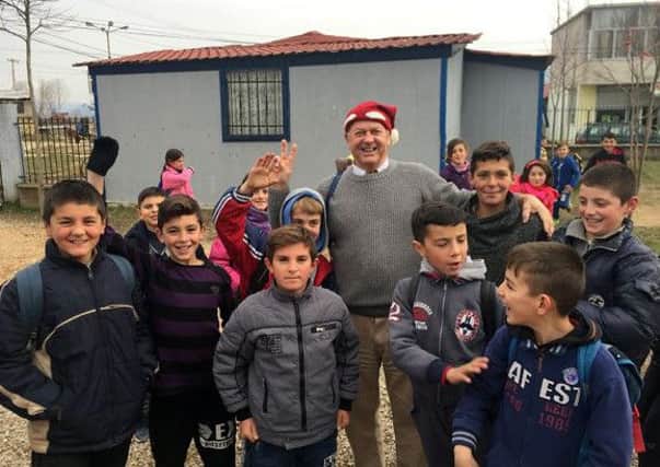 Malcolm Dent, centre, in Albania for the 2016 shoebox appeal. Picture: Malcolm Dent