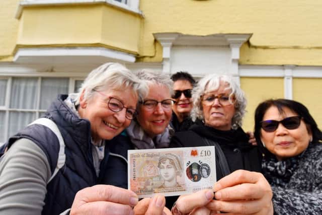 Dutch tourists visiting the house where Jane Austen died in Winchester inspect the new note.
© Solent News & Photo Agency