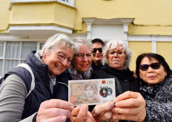Dutch tourists visiting the house where Jane Austen died in Winchester inspect the new note. 
Â© Solent News & Photo Agency