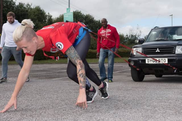 Vicky Clisset pulling her Mitsubishi Shogun 10 car. It proved much more difficult than she thought due to the uneven and gravel covered surface
Picture: Keith Woodland