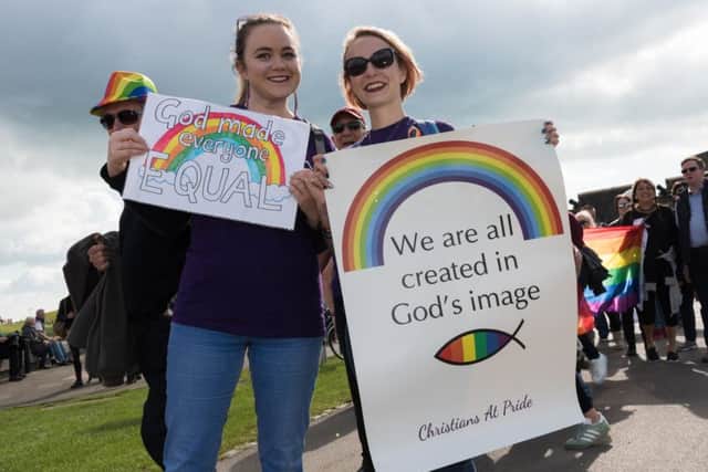 Charlie Stevenson and Laura Craft with their strong message on the Portsmouth Pride parade in Southsea Picture: Duncan Shepherd (171248-028)