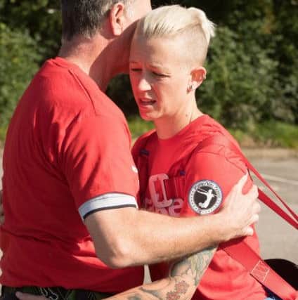 Vicky is comforted by her father Kev Clissett as she struggles around the car park  Picture: Keith Woodland (171020-0056)