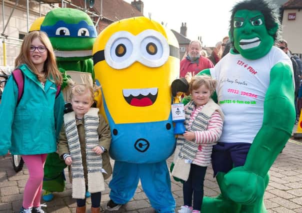 Fun at last year's Tichfield Carnival - from left:  Evelyn Eynon (eight);  Katie (three)  and Molly Nichols (four) with a Ninja Turtle, Minion, and Hulk      Picture: Keith Woodland