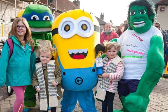 Fun at last year's Tichfield Carnival - from left:  Evelyn Eynon (eight);  Katie (three)  and Molly Nichols (four) with a Ninja Turtle, Minion, and Hulk      Picture: Keith Woodland