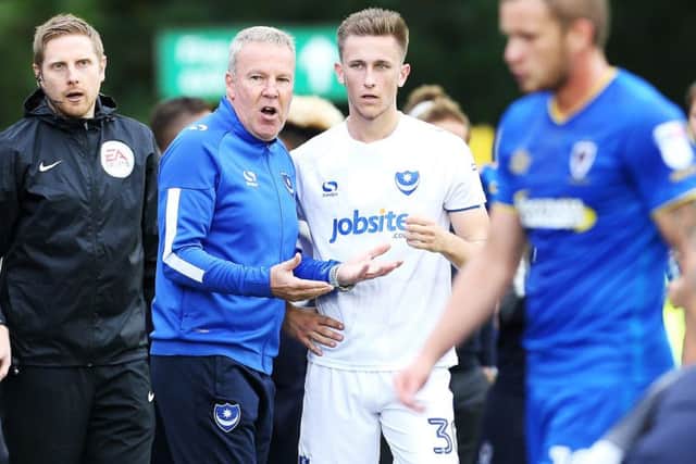 Kenny Jackett talks tactics with Adam May during a break in play at Wimbledon