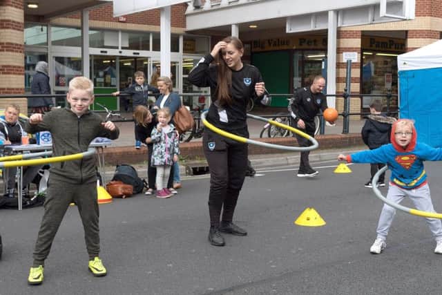 Jack and Samuel Hunter get to grips with the hula hoops with Chelsey Langdon from Pompey in the Community Pictures: Keith Woodland