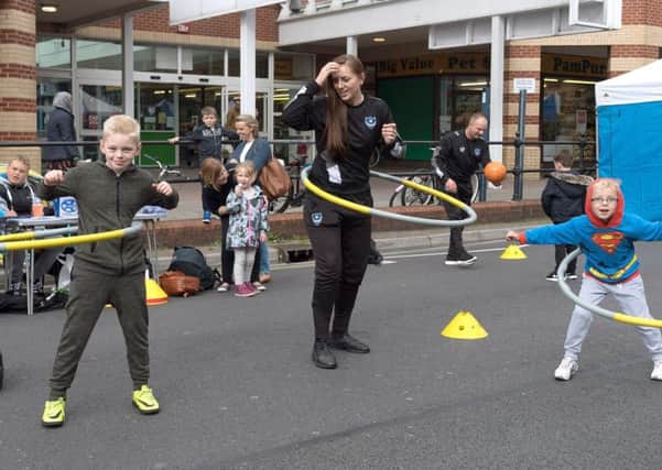 Jack and Samuel Hunter get to grips with the hula hoops with Chelsey Langdon from Pompey in the Community Pictures: Keith Woodland