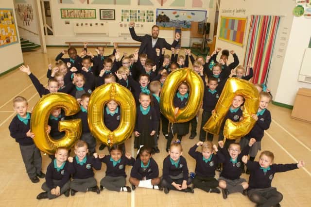 Youngsters at Manor Infant School and Nursery celebrate with headteacher Ashley Howard, centre. Picture: Habibur Rahman