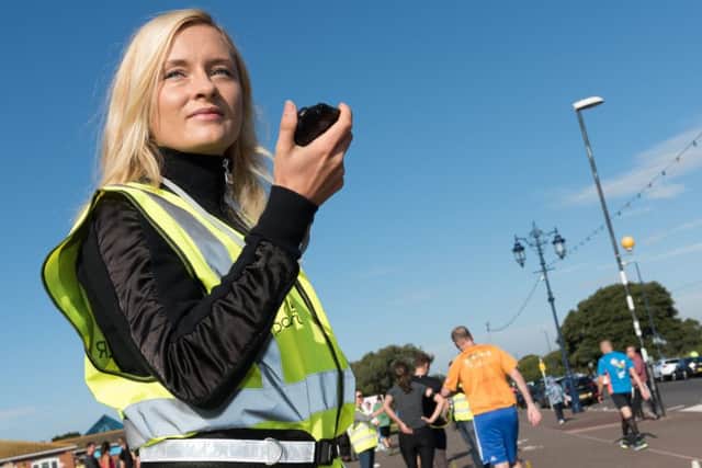 Event volunteer Emma Williams records runners crossing the finish line, Picture: Duncan Shepherd (171256-039)