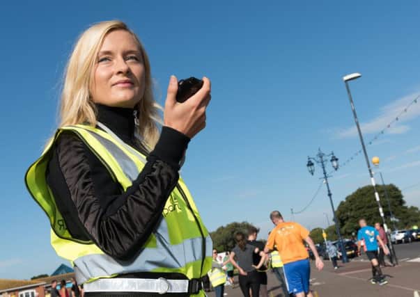 Event volunteer Emma Williams records runners crossing the finish line, Picture: Duncan Shepherd (171256-039)