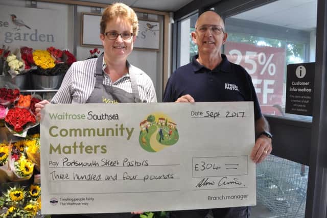 Waitrose Southsea's Community Matters champion, Alice Lawrie, presents a cheque to a Portsmouth street pastor