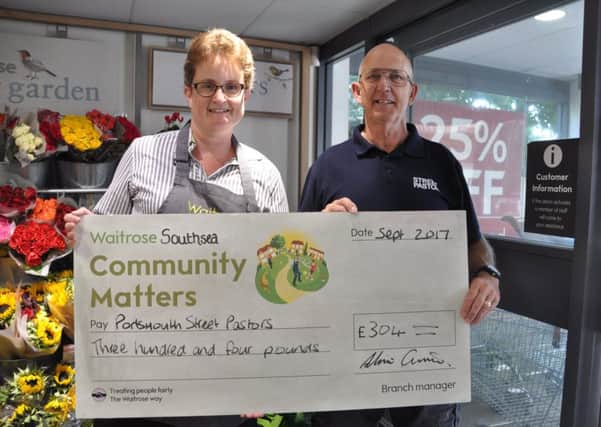 Waitrose Southsea's Community Matters champion, Alice Lawrie, presents a cheque to a Portsmouth street pastor