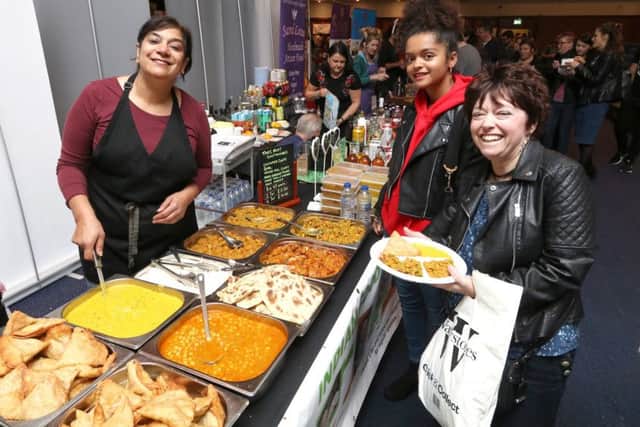 Jas Dhillon of Home Vegan Kitchen dishing out vegan meals to Julie and Esme Bediako Picture: Habibur Rahman