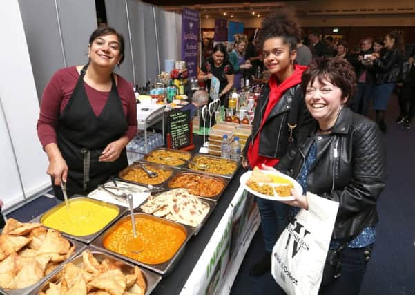 Jas Dhillon of Home Vegan Kitchen dishing out vegan meals to Julie and Esme Bediako Picture: Habibur Rahman