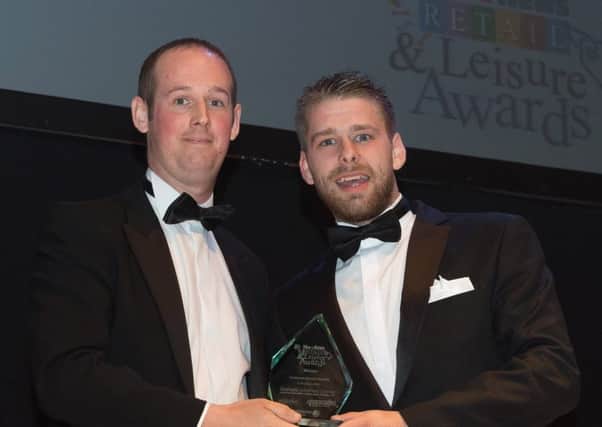 Fareham Shopping Centre manager Mike Taylor presents the Customer Service Award to Johnny White of Timpson Picture: Keith Woodland