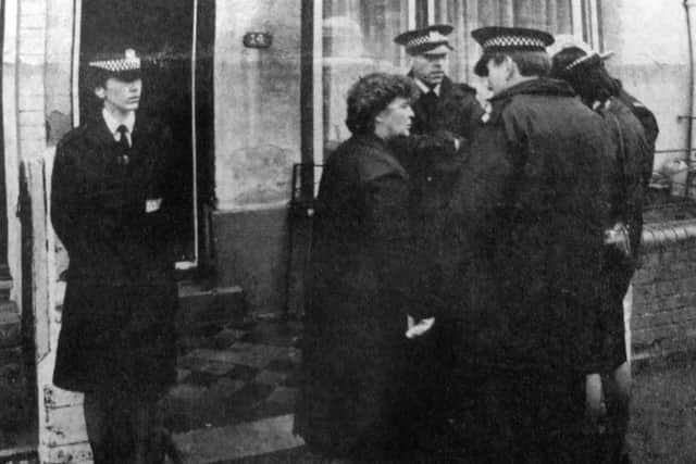 Police offivers outside the house at Landport where one child was killed and another seriously injured in a fire