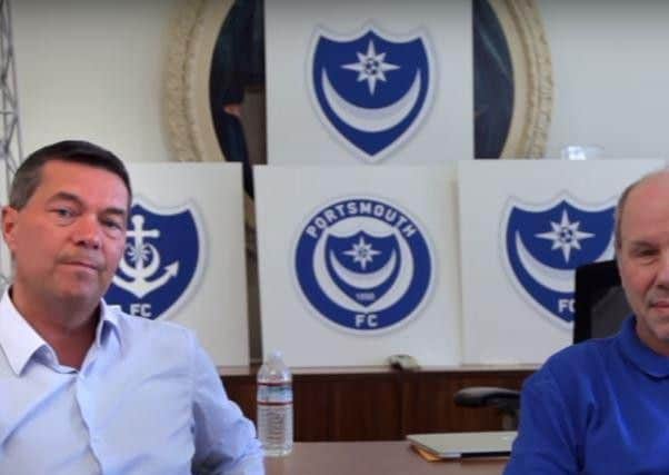 Pompey chief executive Mark Catlin, left, with club owner Michael Eisner with five Pompey badge designs in the background