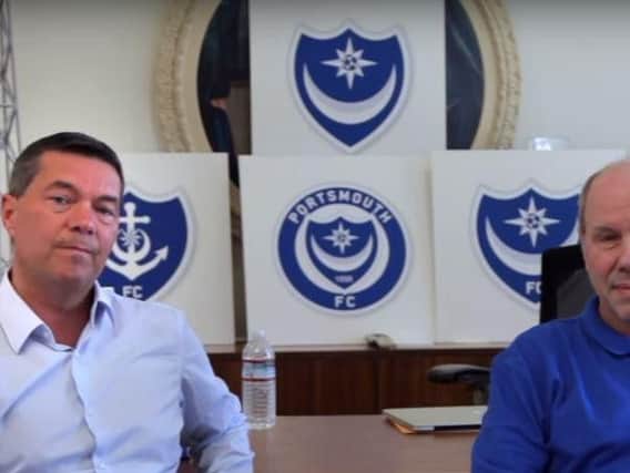 Pompey chief executive Mark Catlin, left, with club owner Michael Eisner with five Pompey badge designs in the background
