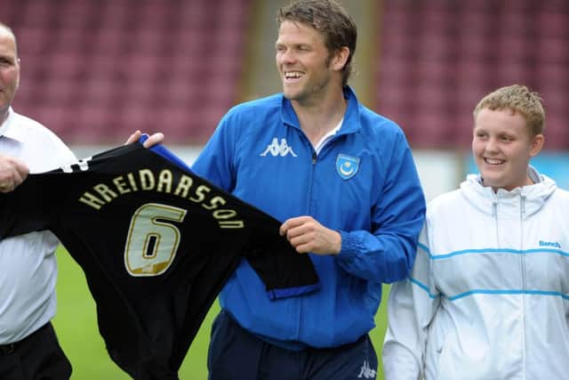 Hermann Hreidarsson is all smiles after retrieving his shirt from the advertising hoarding at Glandford Park in 2011 Picture: Joe Pepler