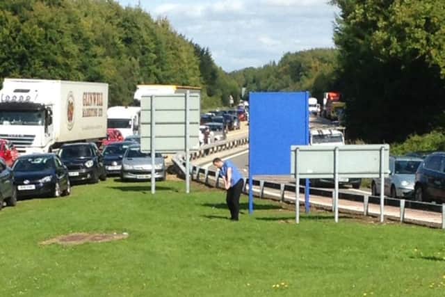 Picture released by the Press Association taken with permission from the Twitter feed of George Vitelis of a man practising golf as traffic is at standstill on the M3
