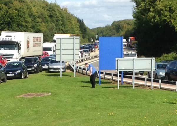 Picture released by the Press Association taken with permission from the Twitter feed of George Vitelis of a man practising golf as traffic is at standstill on the M3