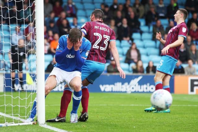 Oliver Hawkins holds his head in his hands after his missed header during the first half at Scunthorpe Picture: Joe Pepler