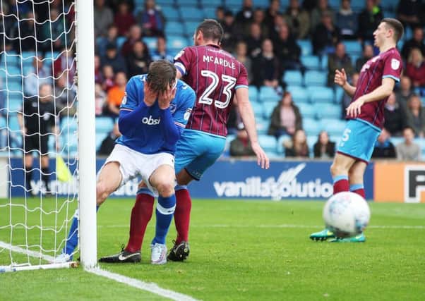 Oliver Hawkins holds his head in his hands after his missed header during the first half at Scunthorpe Picture: Joe Pepler