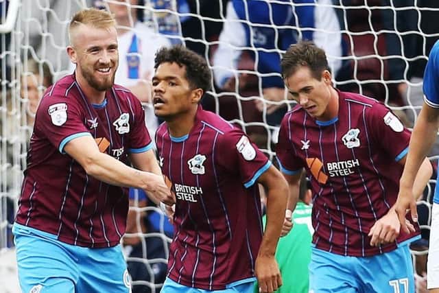 Duane Holmes, centre, scored Scunthorpe's second goal in the 2-0 win Picture: Joe Pepler