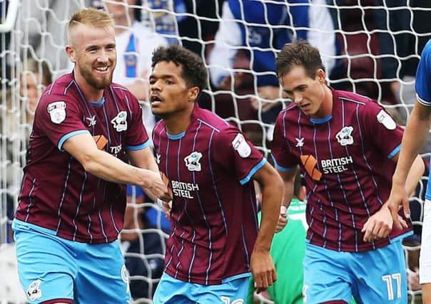 Duane Holmes, centre, scored Scunthorpe's second goal in the 2-0 win Picture: Joe Pepler