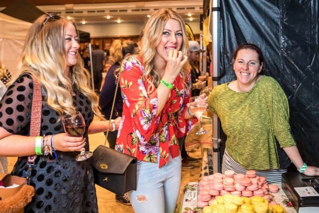 Sam Hall watches while Hannah Sillence tries a cheese macaroon from Elena Floarea of Lola's Cake Away
Pictures: Mike Cooter