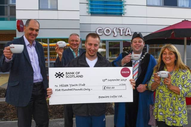 Deputy Lord Mayor of Portsmouth, Councillor Lee Mason with Matt Thomas who uses LDD (holding cheque), Andy Hirst and Robin Arkle of Costa and LDD Youth Club members. Picture: Robin Jones/Digital South
