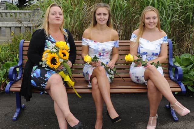(left to right) Wife of the late Michael Robinson, Sue Robinson and daughters Shannon Robinson and Georgia Robinson take a few moments on the new bench