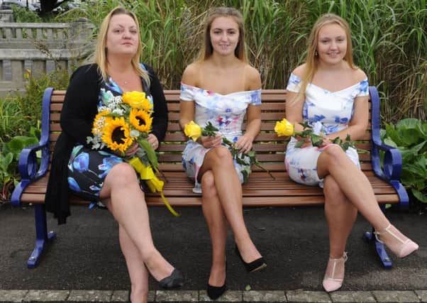 (left to right) Wife of the late Michael Robinson, Sue Robinson and daughters Shannon Robinson and Georgia Robinson take a few moments on the new bench