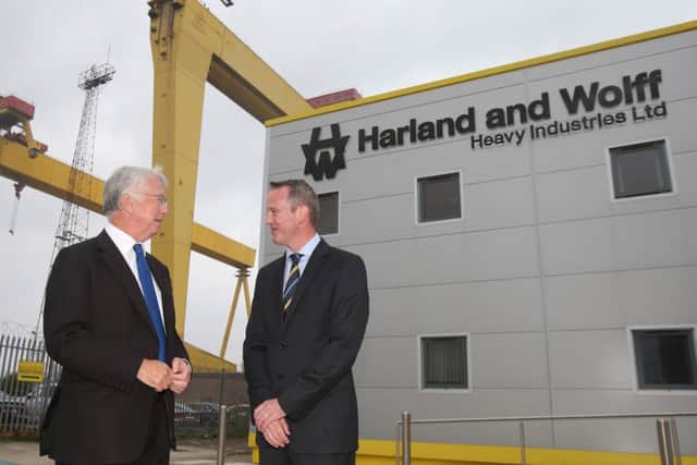 Harland and Wolff's director of business development and improvement Jonathan Guest with with Defence Secretary Sir Michael Fallon, left, in Belfast Picture: Niall Carson/PA Wire