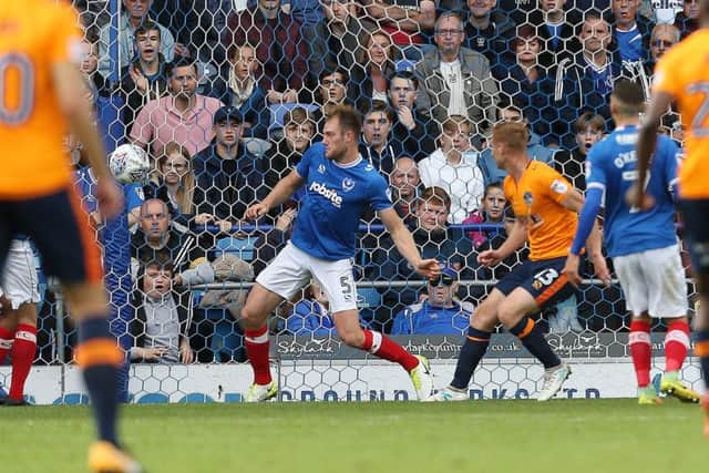 Eoin Doyle scores Oldham's opening goal in their 2-0 win against Pompey Picture: Joe Pepler