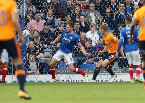 Eoin Doyle scores Oldham's opening goal in their 2-0 win against Pompey Picture: Joe Pepler