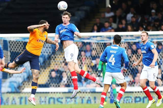 Pompey's Oliver Hawkins heads the ball in their League One match against Oldham. Picture Joe Pepler/Digital South