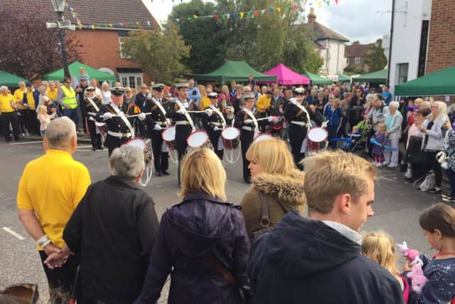 Fayre crowds enjoy a rendition from the marching band